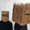 two figures wearing cardboard helmets
